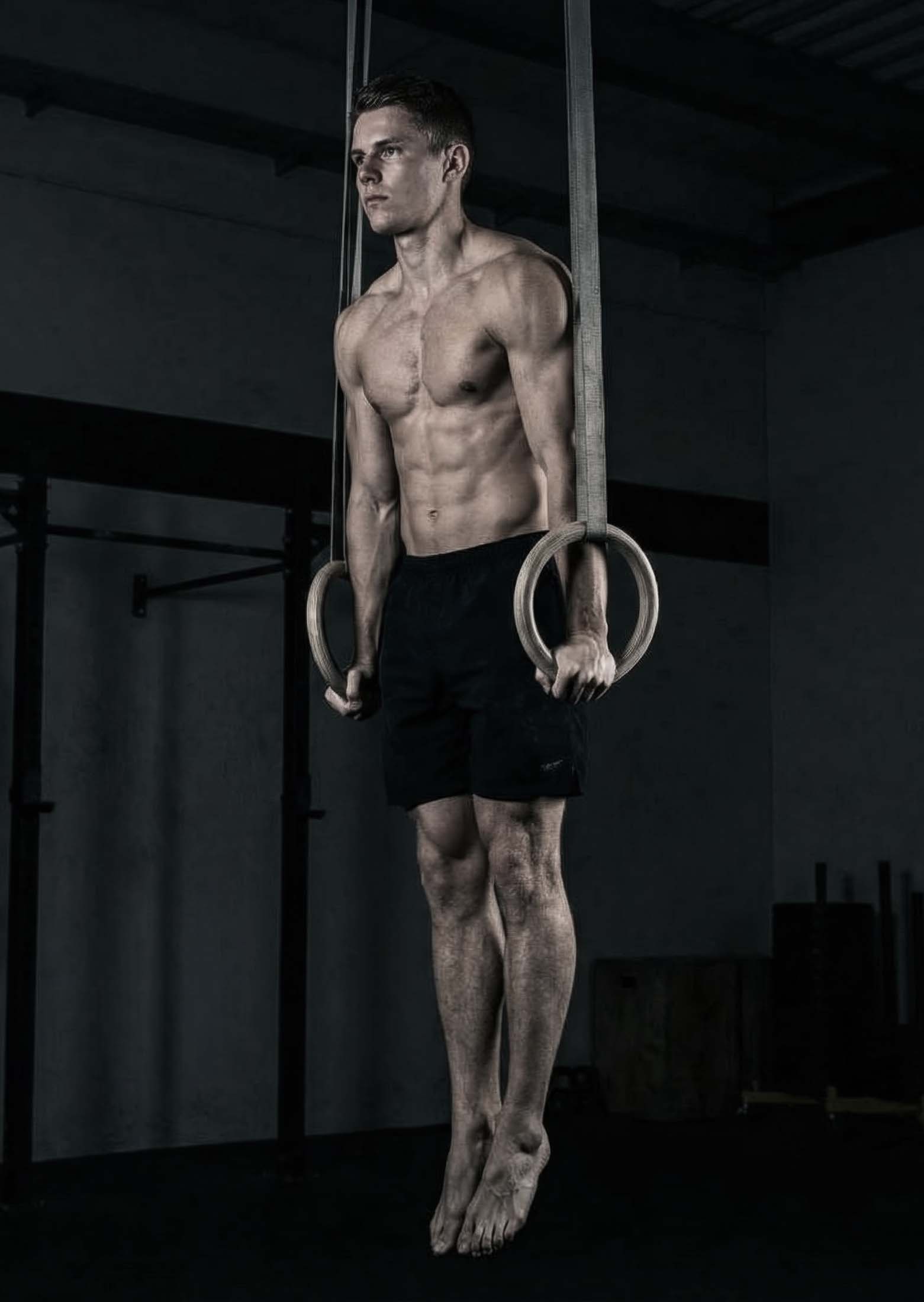 Athlete holding a stable support position on gymnastic rings